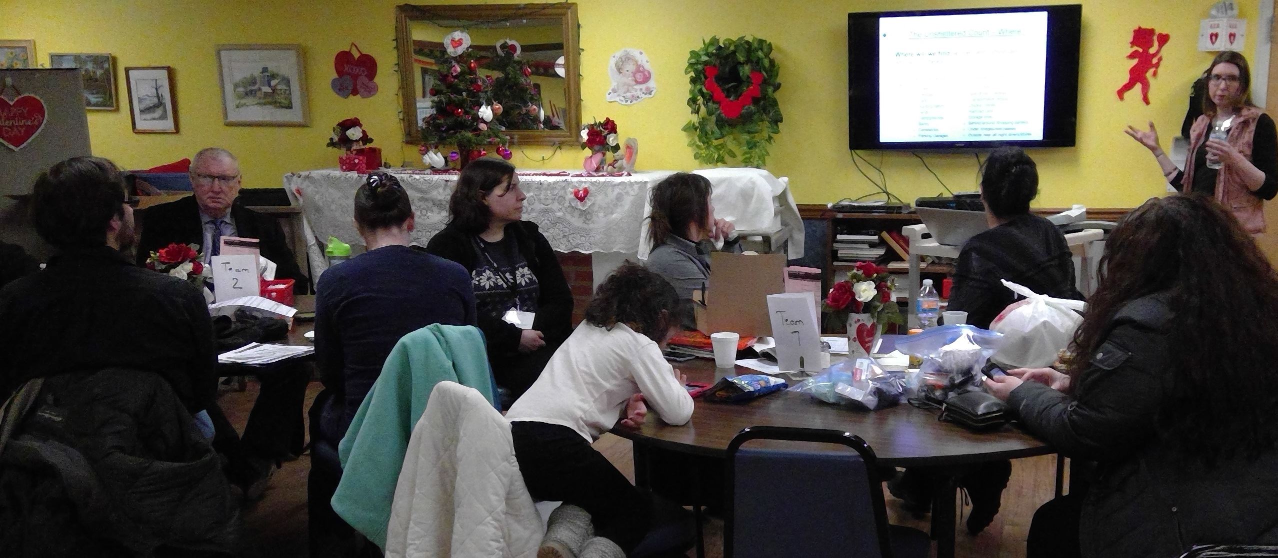 County staff member presents a briefing to volunteers gathered to conduct a homeless count.