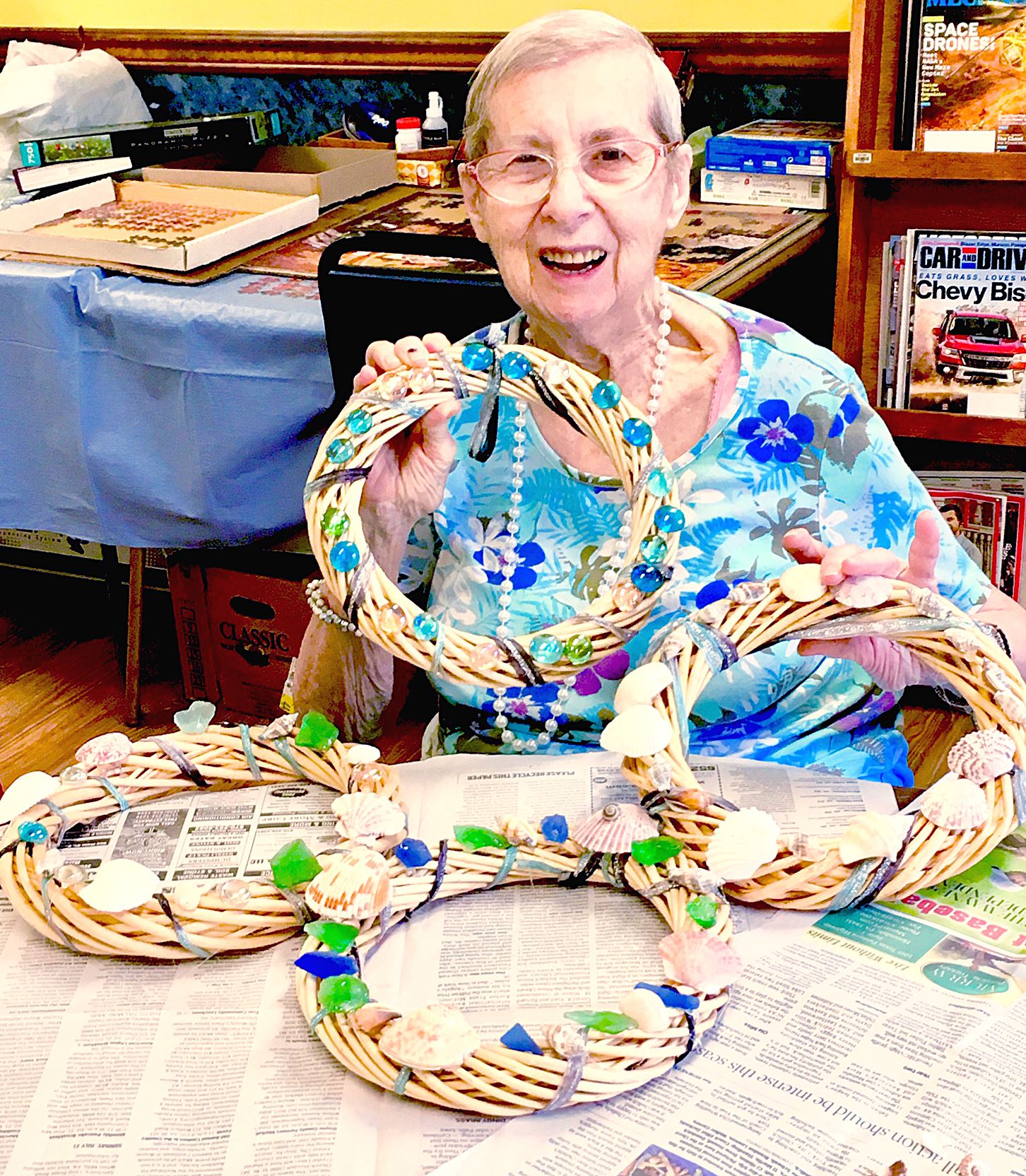 Honesdale Senior Center attendee NancyDavis poses with the decorative summer wreath made by the free