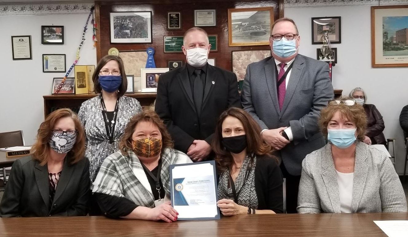 The County Commissioners and representatives of Wayne Tomorrow! display the USDA designatiion.