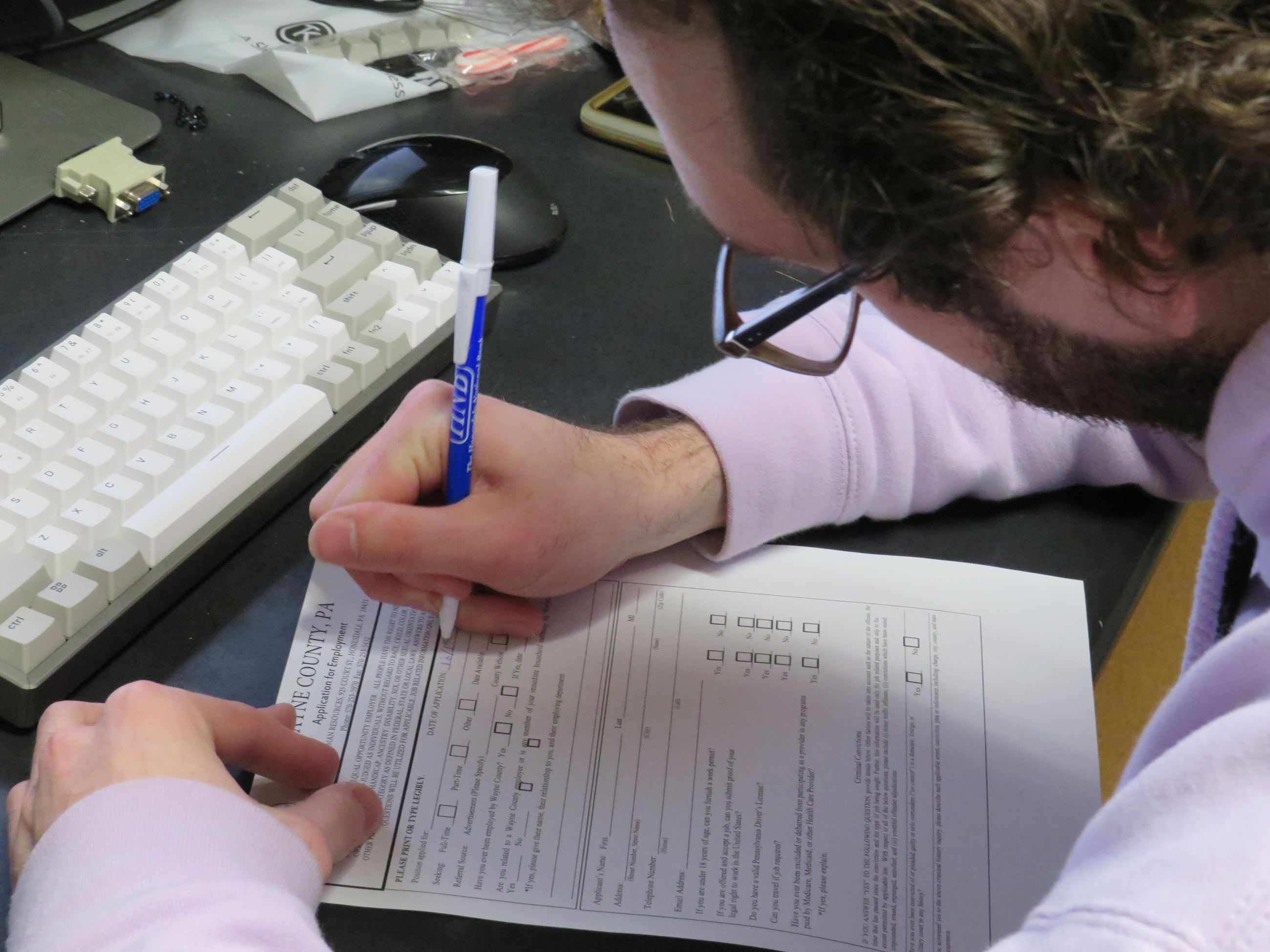 An young man fills out a Wayne County job application.