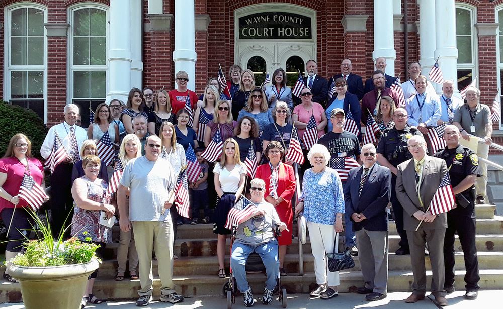 Onlookers gather on the steps of the Courthouse following the annual Flag Day Ceremony.