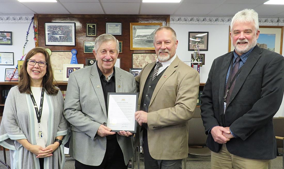 Dave Williams receives a proclamation from the Commissioners for 25 years of Ag broadcasting.